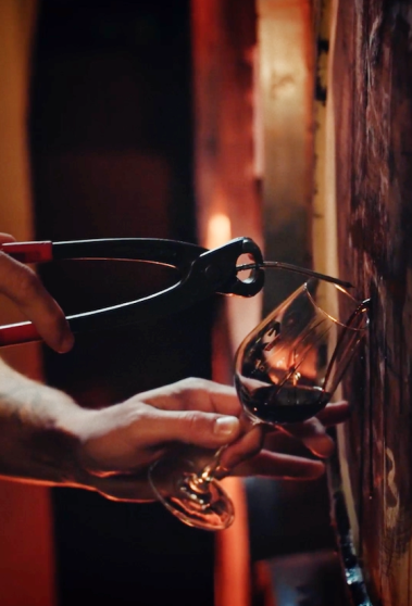 Pulling a nail from a wooden barrel to fill a Moersleutel glass with a barrel aged beer