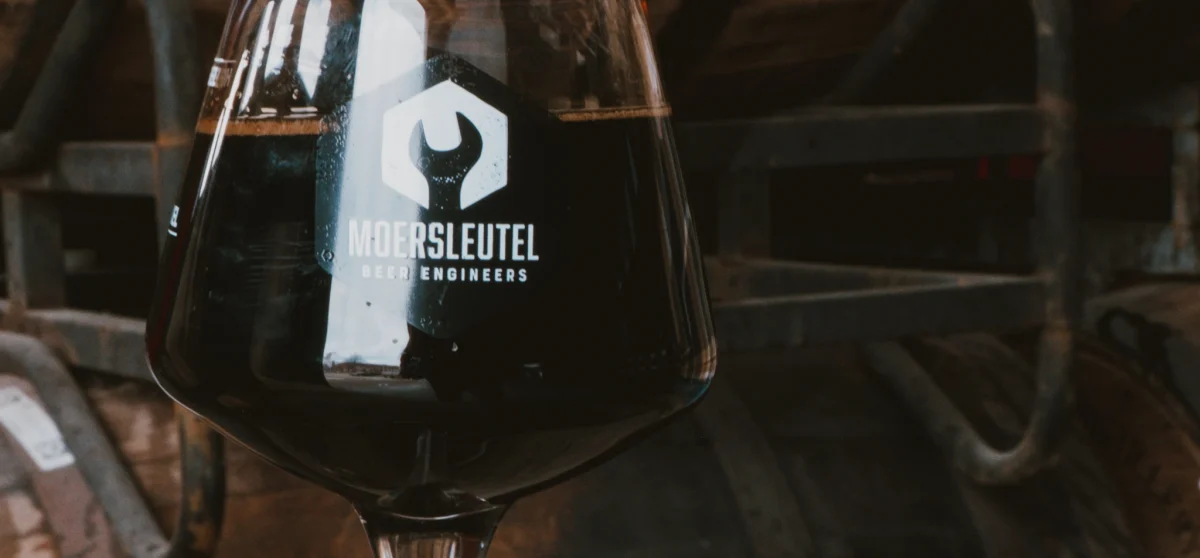 Glass of dark imperial stout perfect with aged Gouda for a craft beer and cheese tasting