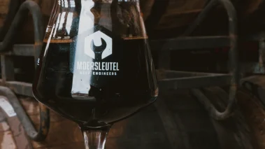 Glass of dark imperial stout perfect with aged Gouda for a craft beer and cheese tasting