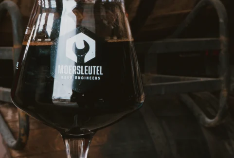 Glass of dark imperial stout perfect with aged Gouda for a craft beer and cheese tasting